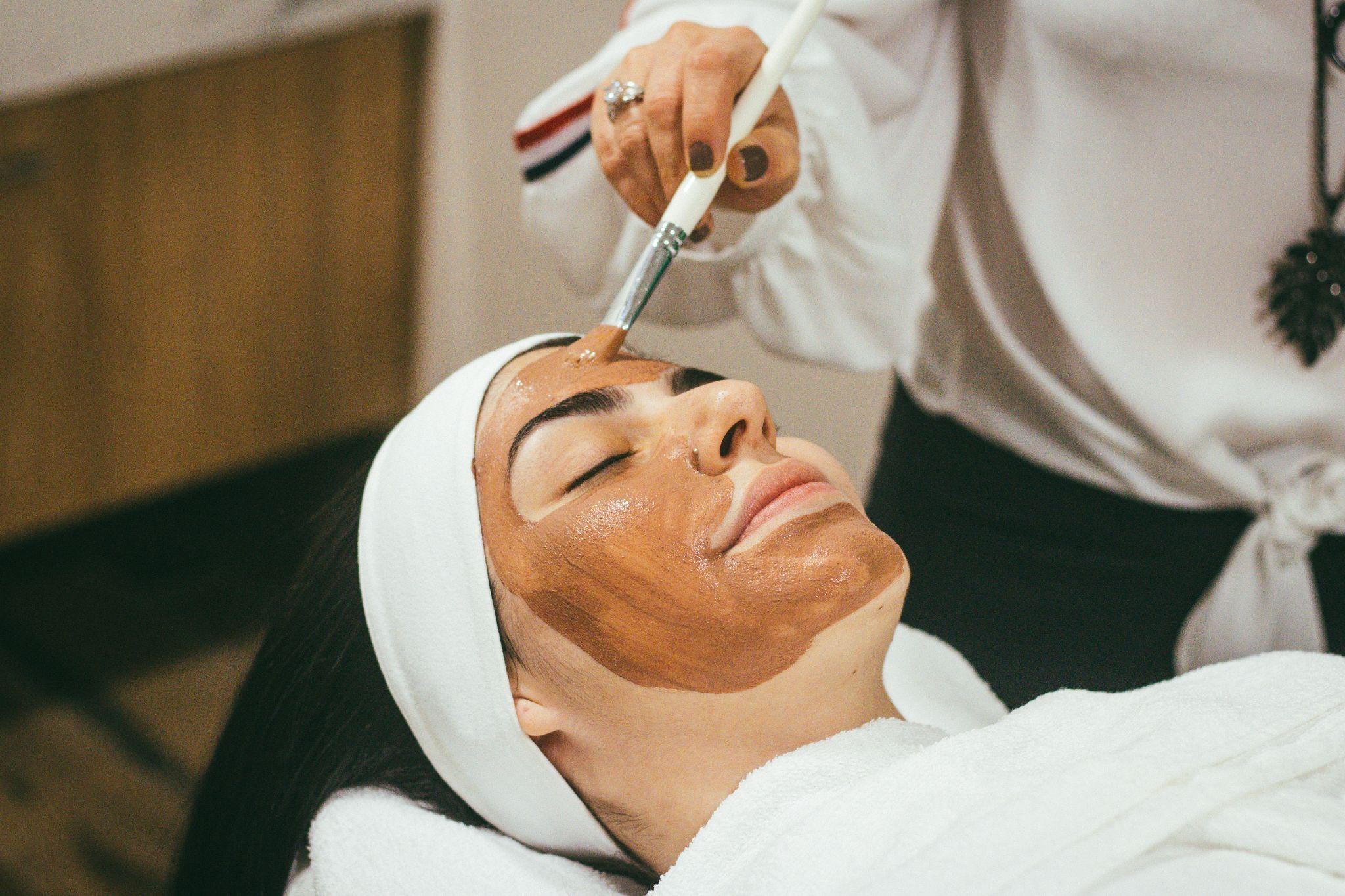 A client relaxes while a skincare specialist applies a nourishing mask for facial skin care in Las Vegas.
