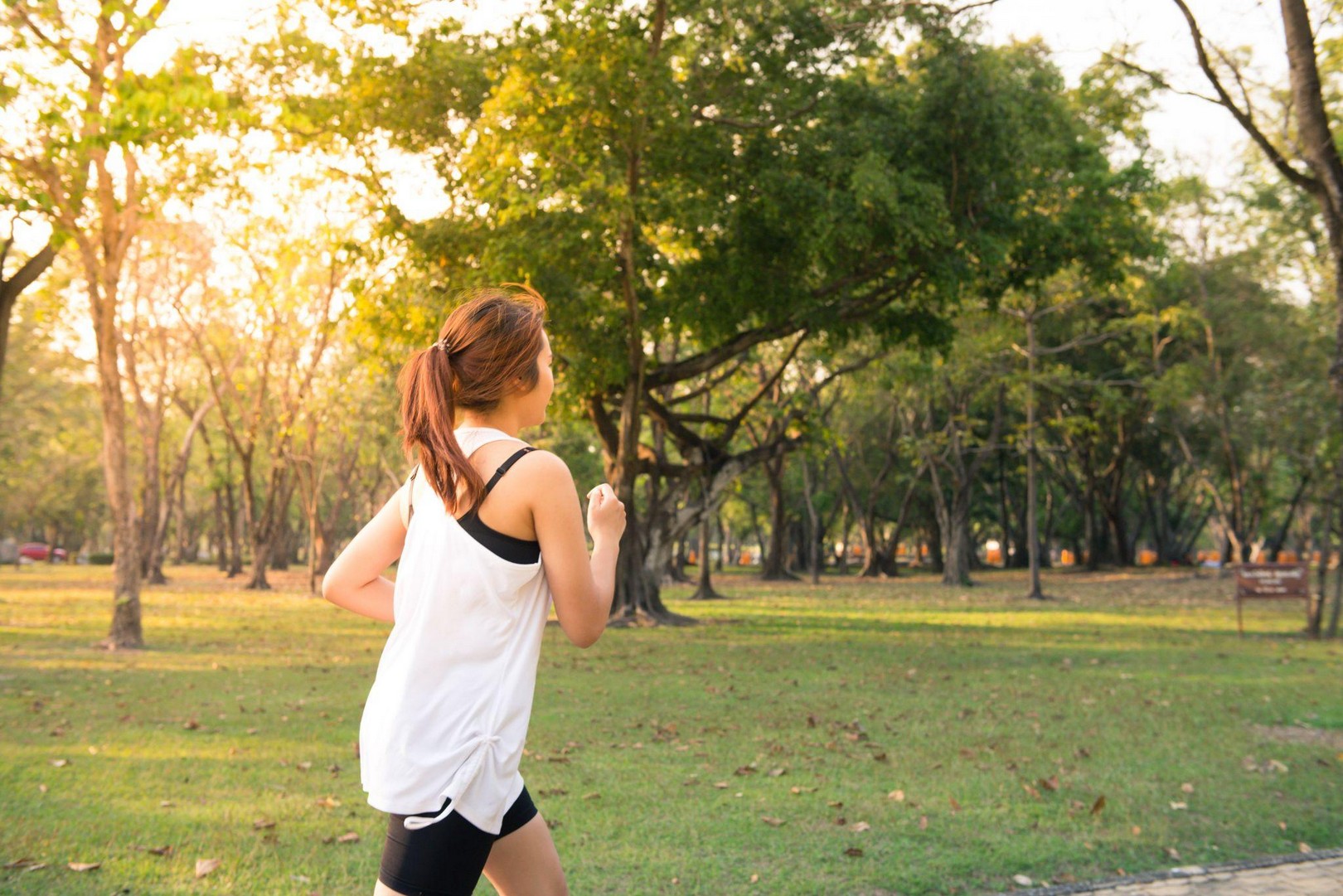 Woman running outdoors in athletic clothing