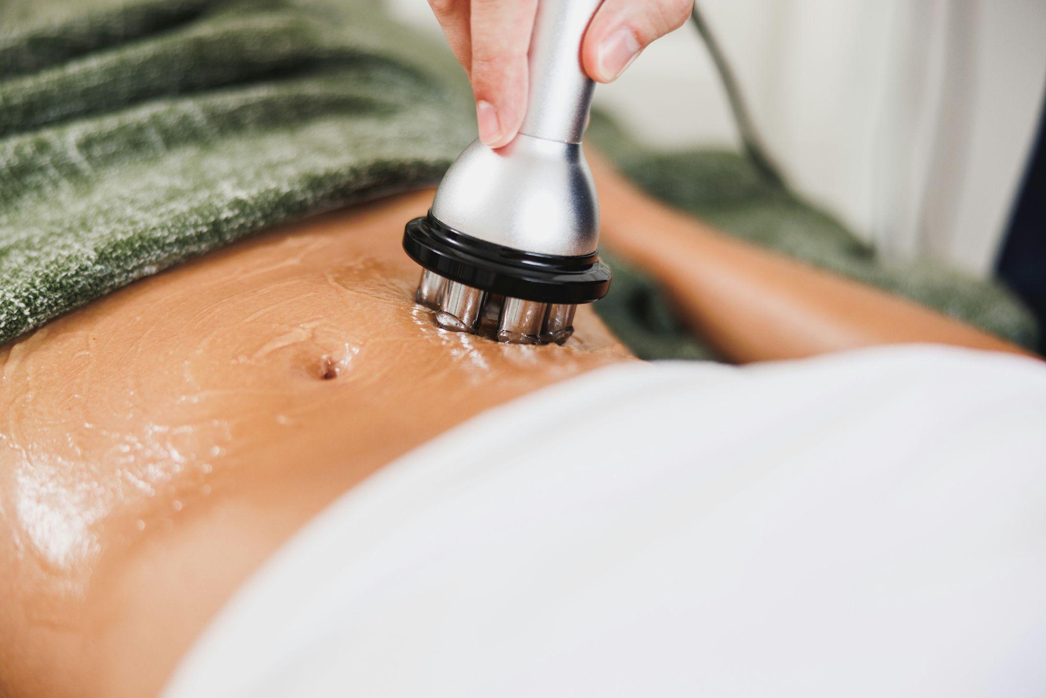 A client receives body sculpting in Henderson treatment for body shaping.