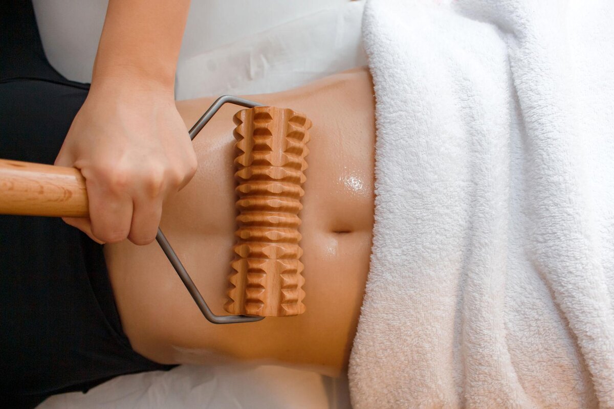 Professional wood therapy massage in Spring Valley using a wooden roller during a relaxing body wellness session.